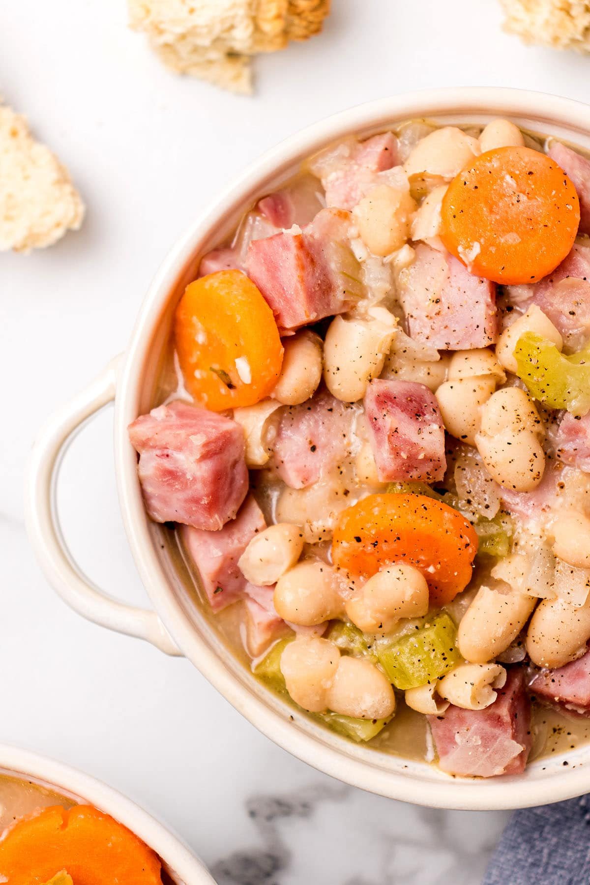 ham and bean soup in a white soup bowl