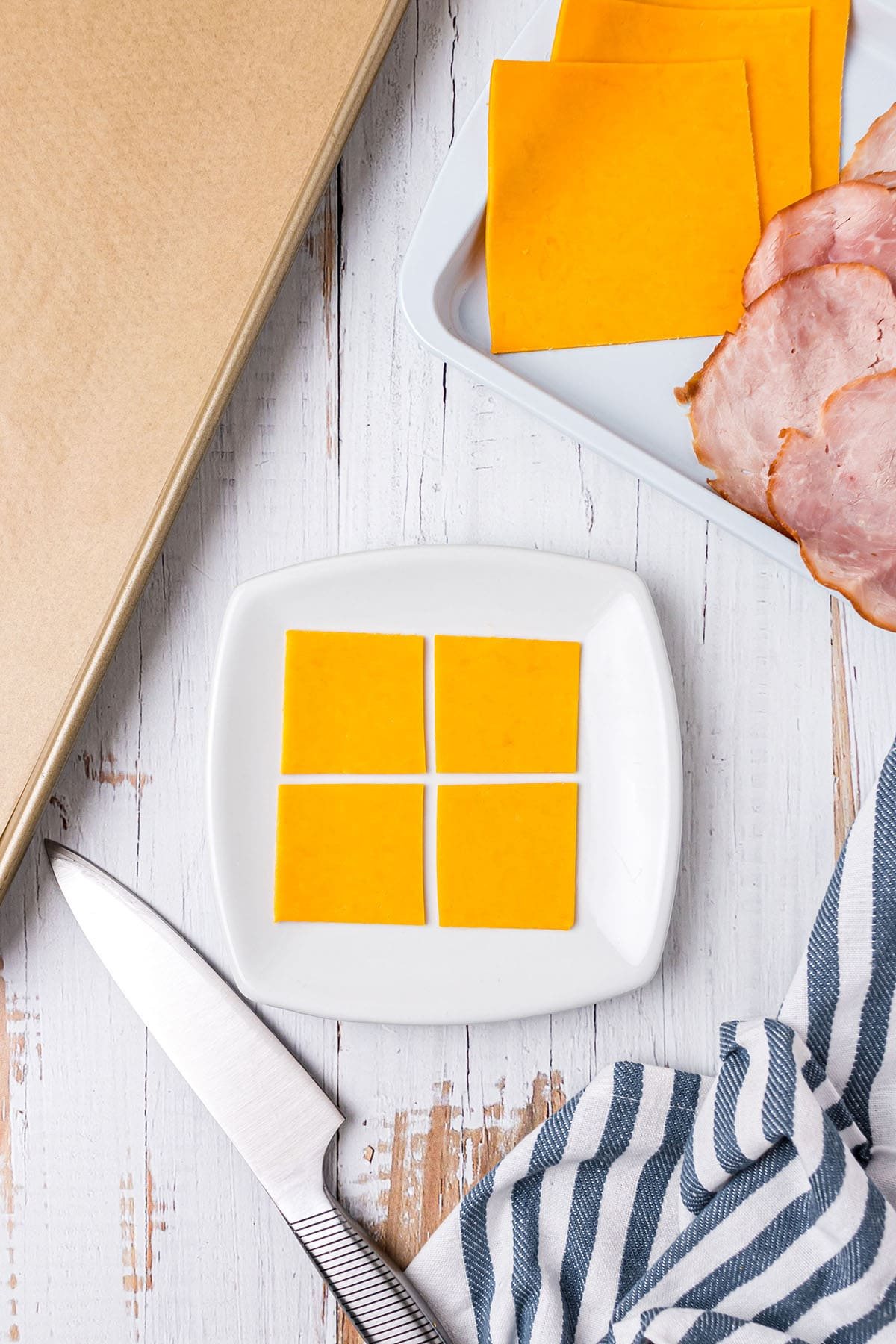 cut cheese slices into 4 smaller squares