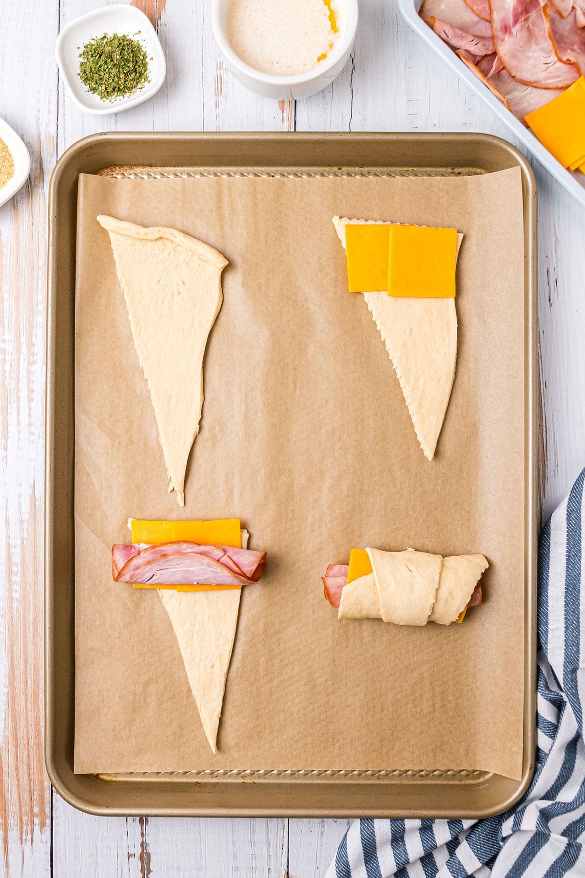 lay ham and cheese on crescent roll triangles and roll up