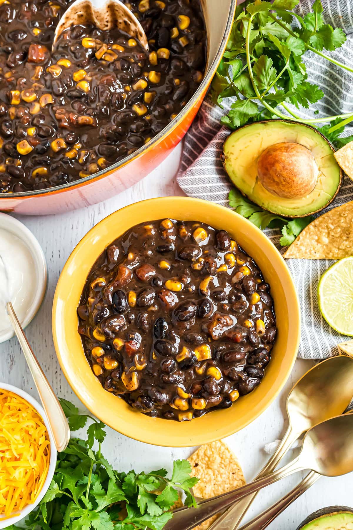 orange pot and yellow bowl full of black bean soup