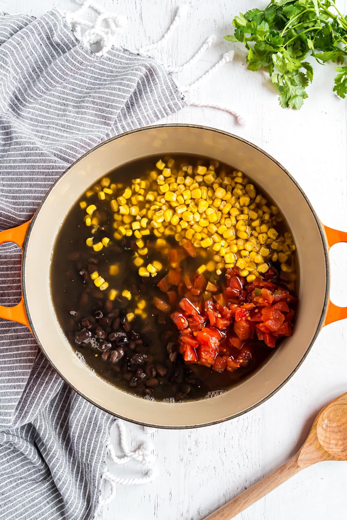 pot of bean soup with blue and white stripe towel