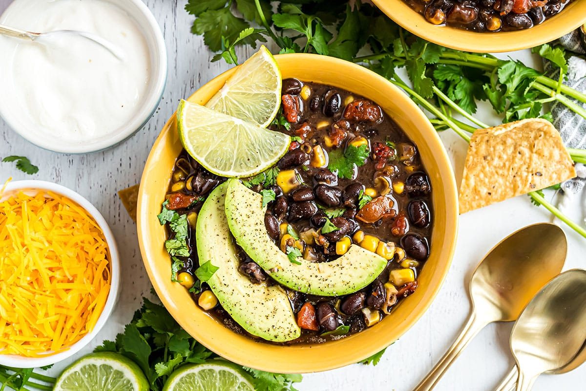 bowl of southwest black bean soup with garnishes