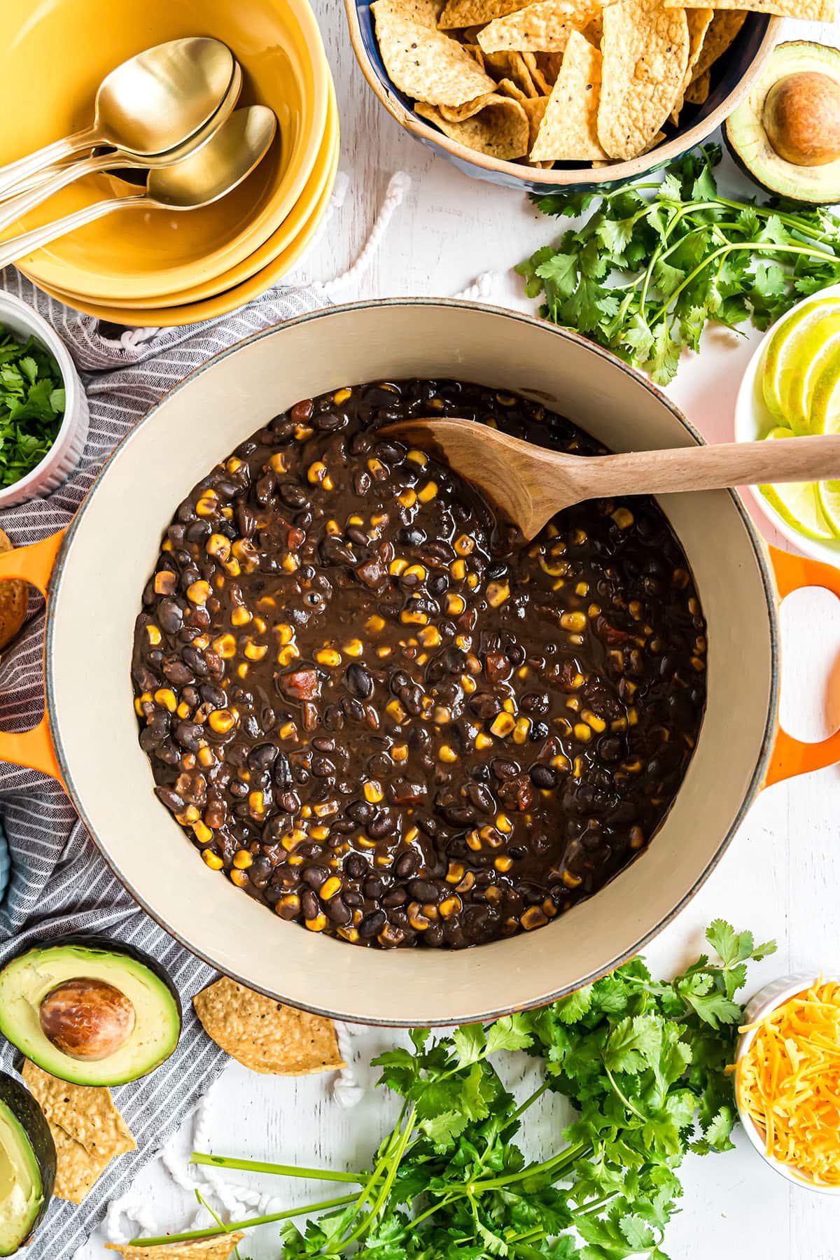 soup pot with southwest black bean soup and a wooden spoon