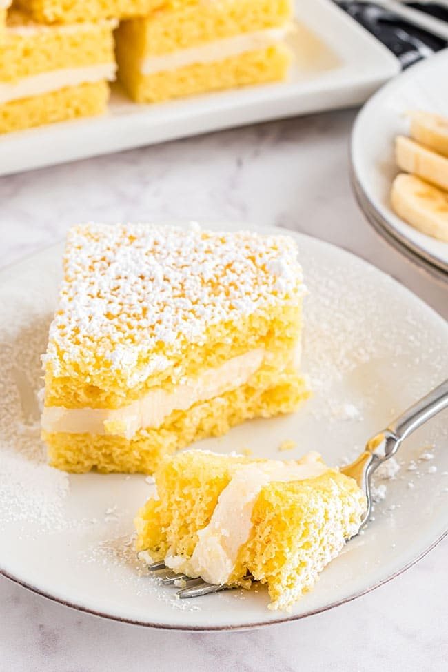 Banana Flips snack cakes on a white plate with a fork