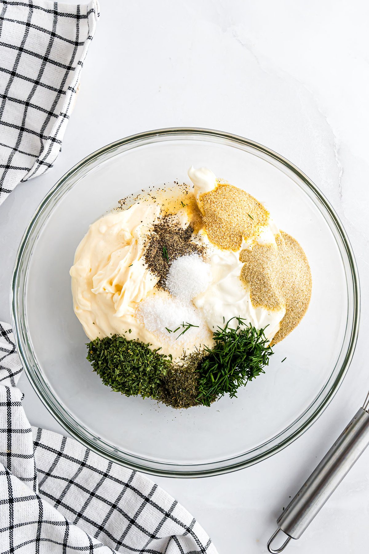 ingredients for ranch dressing recipe in a glass bowl
