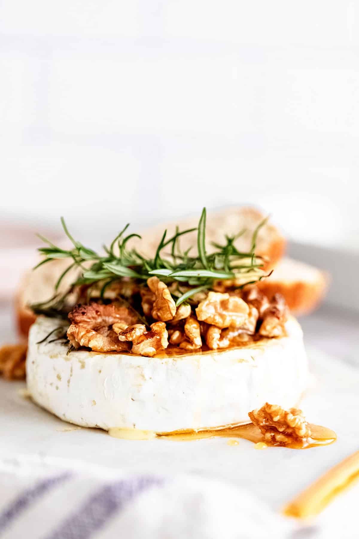 cheese wheel with honey, walnuts and fresh rosemary