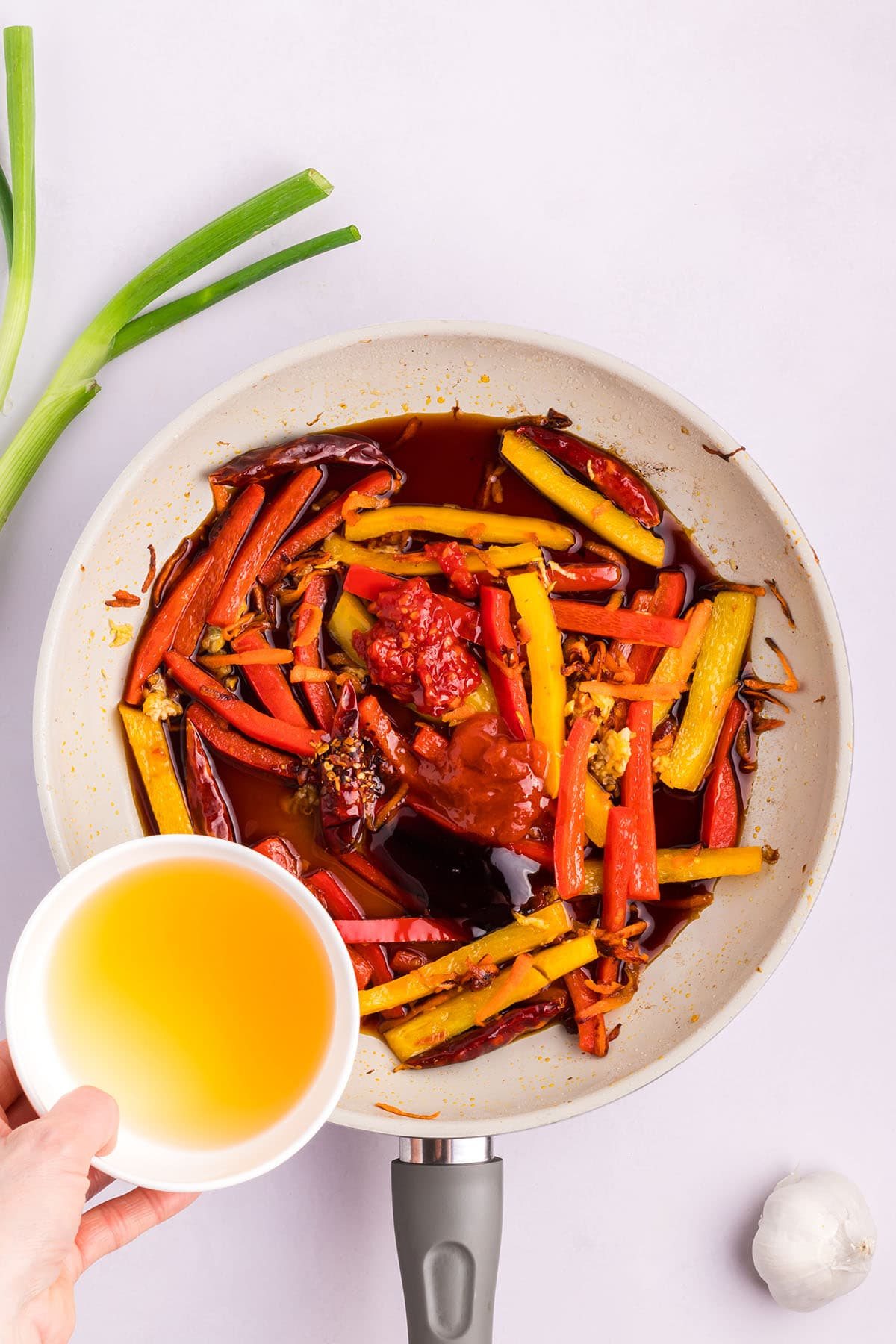 sauteed veggies in a white skillet