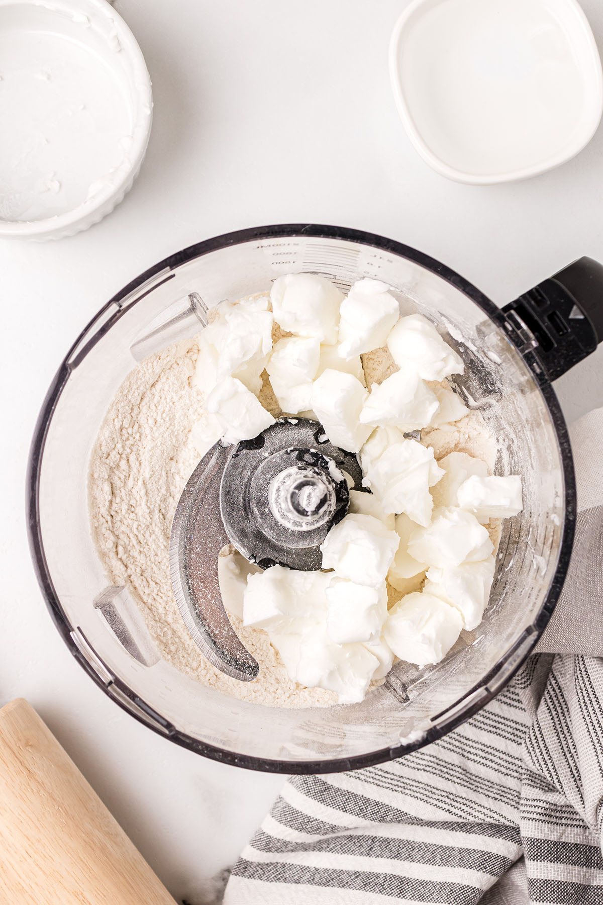 combining shortening, flour, salt and sugar in a food processor to make pie crust