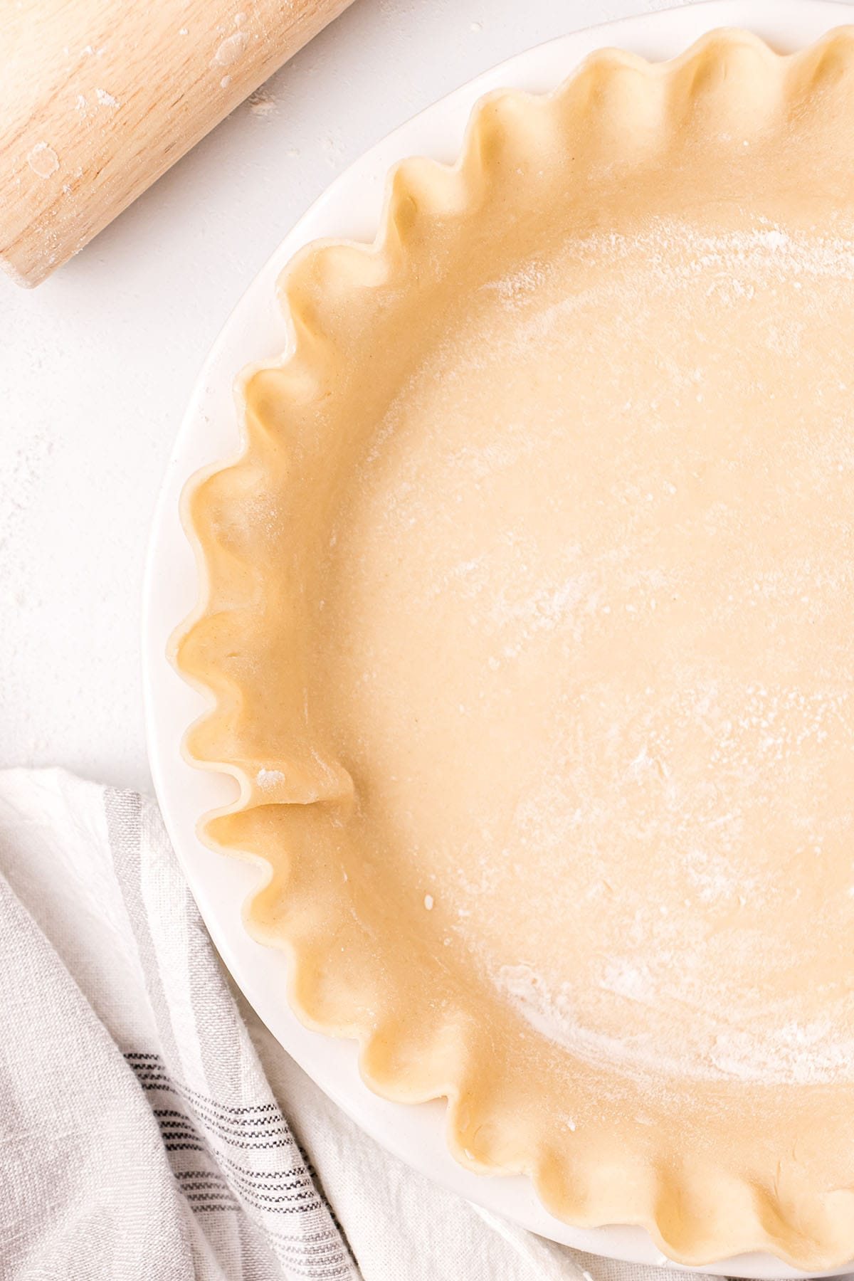 close up of unbaked pie crust in a pie dish.