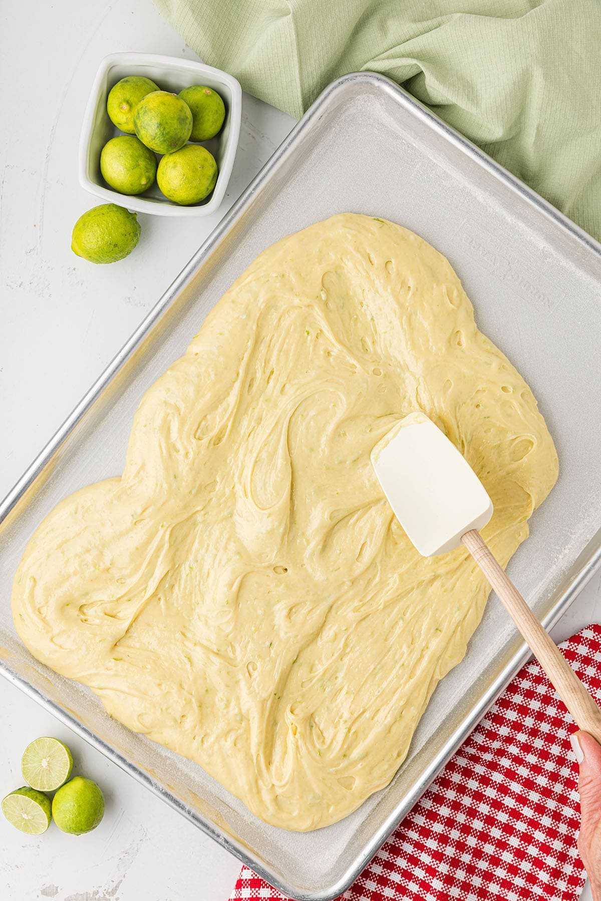 cake batter poured into a half sheet pan
