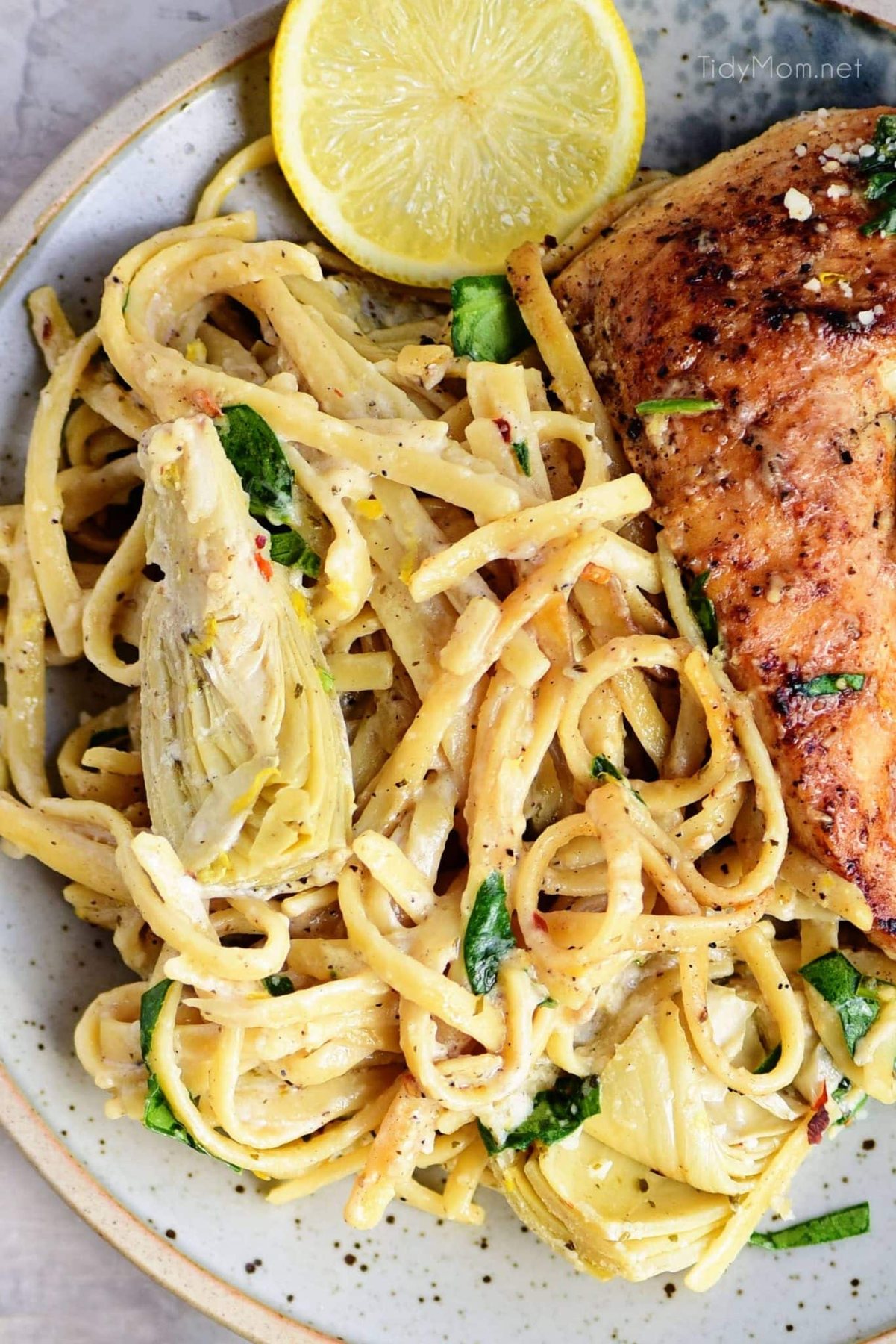 artichoke pasta with a chicken on a plate