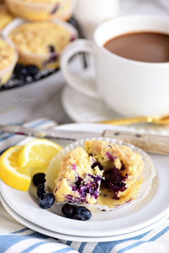 LEMON BLUEBERRY MUFFINS cut open served with mug of coffee