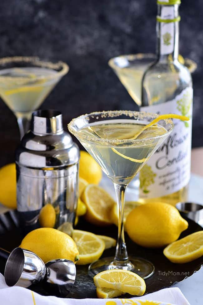 Lemon Drop Martinis on tray with a bottle of elderflower cordial