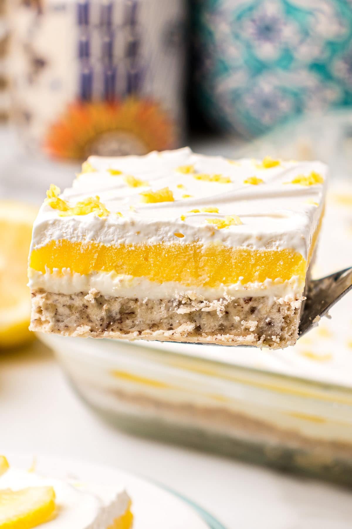 serving of creamy lemon lush on a spatula