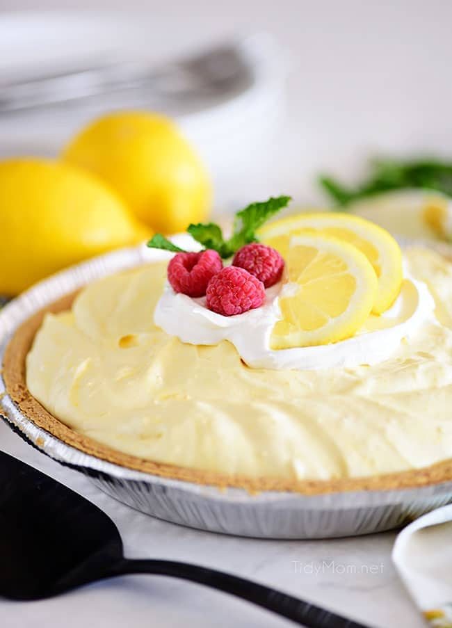 Cold lemonade pie garnished with lemon slices and raspberries