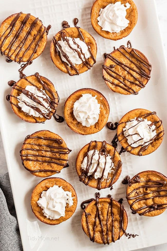 crustless mini pumpkin pies with whipped cream and chocolate drizzle