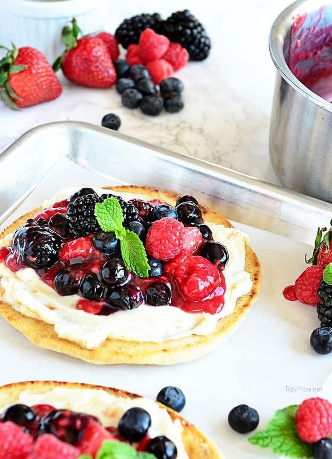 Berry Breakfast pizza tastes as good as it looks! It's impossible to resist the toasted flatbread crust, rich orange mascarpone layer and glossy berry topping. It's so convenient to prepare the night before and serve the next morning, or any time of day! Full recipe at cetcu.com