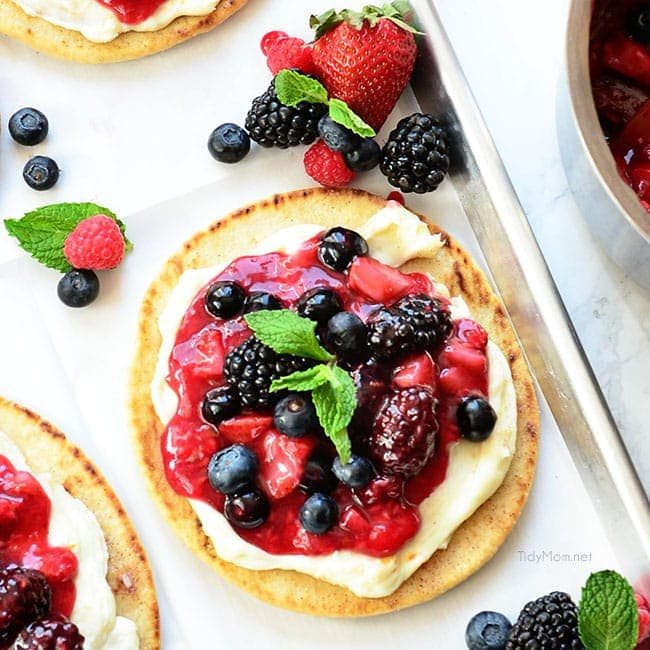 Berry Breakfast pizza tastes as good as it looks! It's impossible to resist the toasted flatbread crust, rich orange mascarpone layer and glossy berry topping. It's so convenient to prepare the night before and serve the next morning, or any time of day! Full recipe at cetcu.com