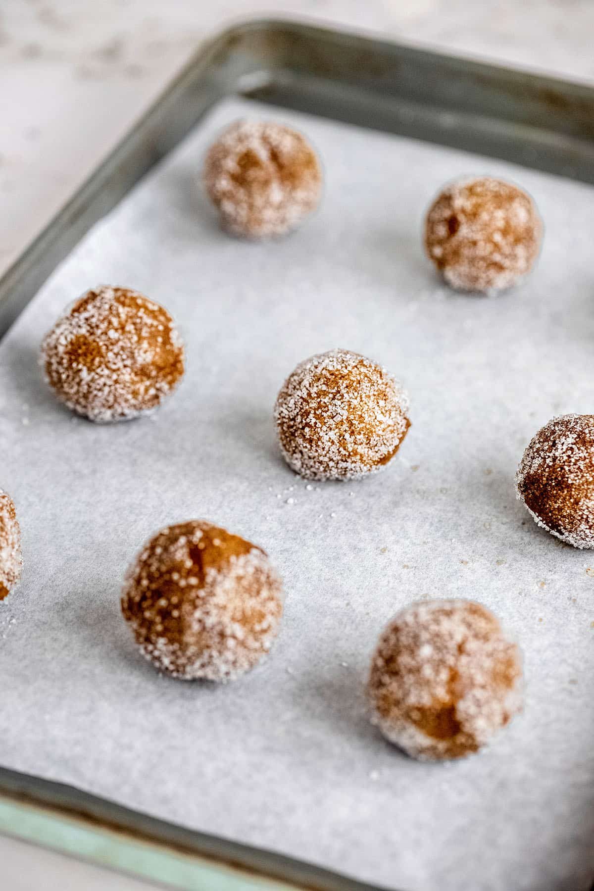 cookie dough balls on a baking sheet