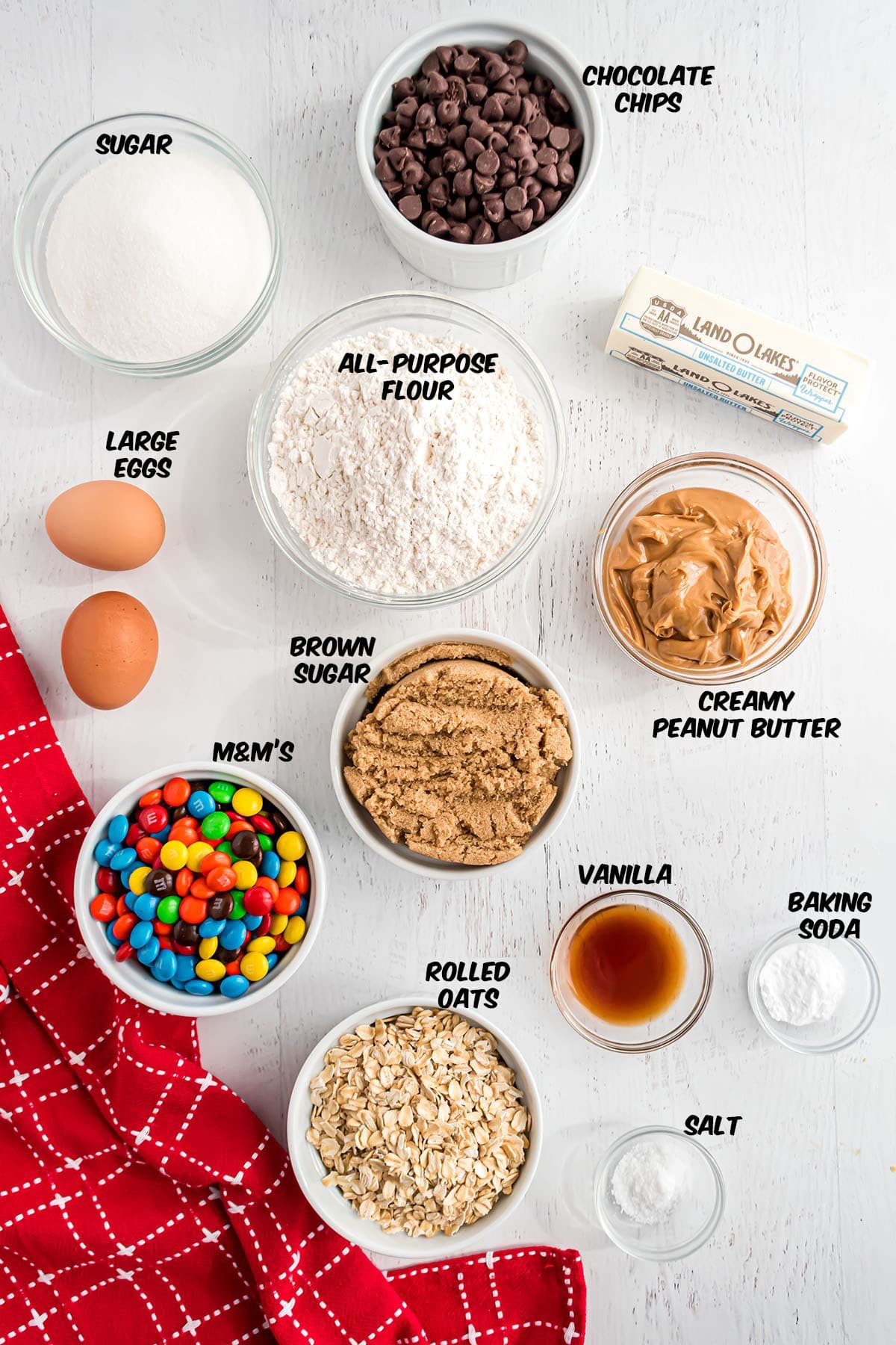 ingredients for monster cookies on a counter with a red towel