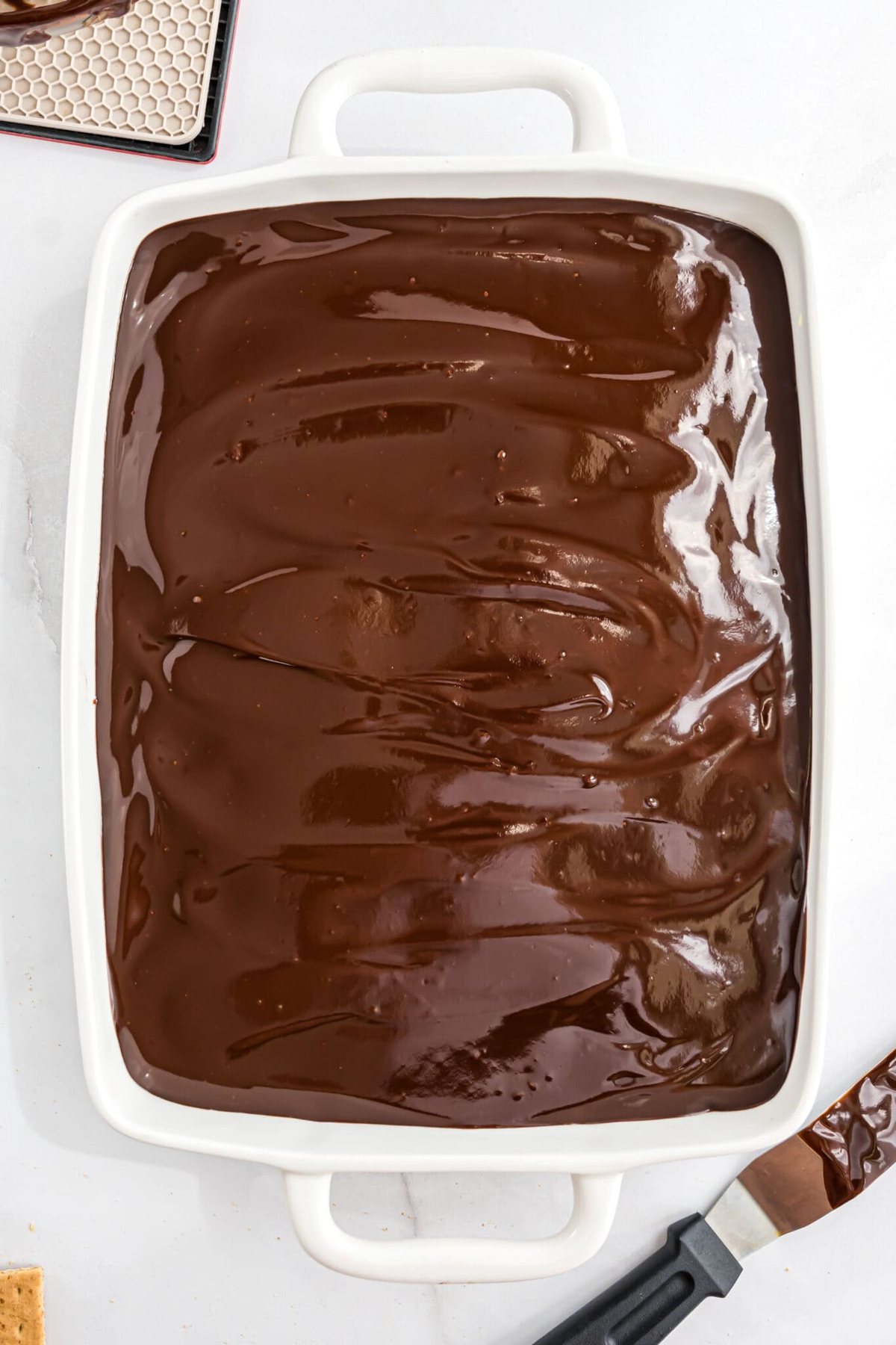 chocolate ganache on a no bake eclair cake