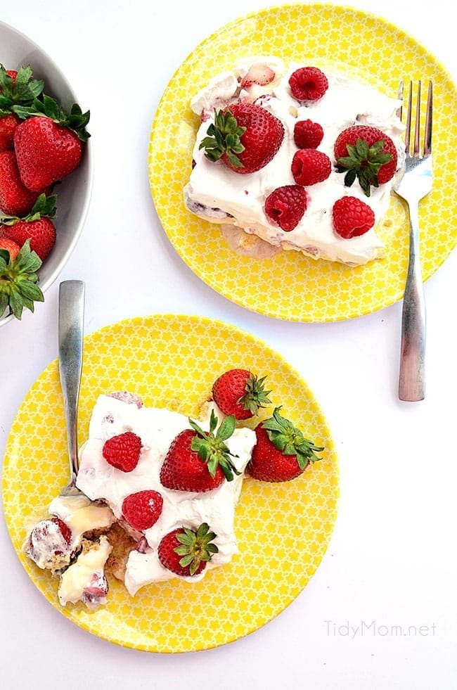 overhead shot of 2 servings of no-bake strawberry cheesecake lush on yellow plates