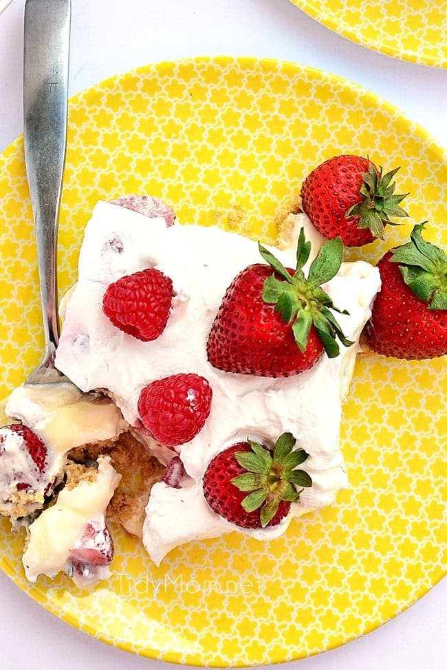 overhead shot of no-bake strawberry cheesecake lush on a yellow plate