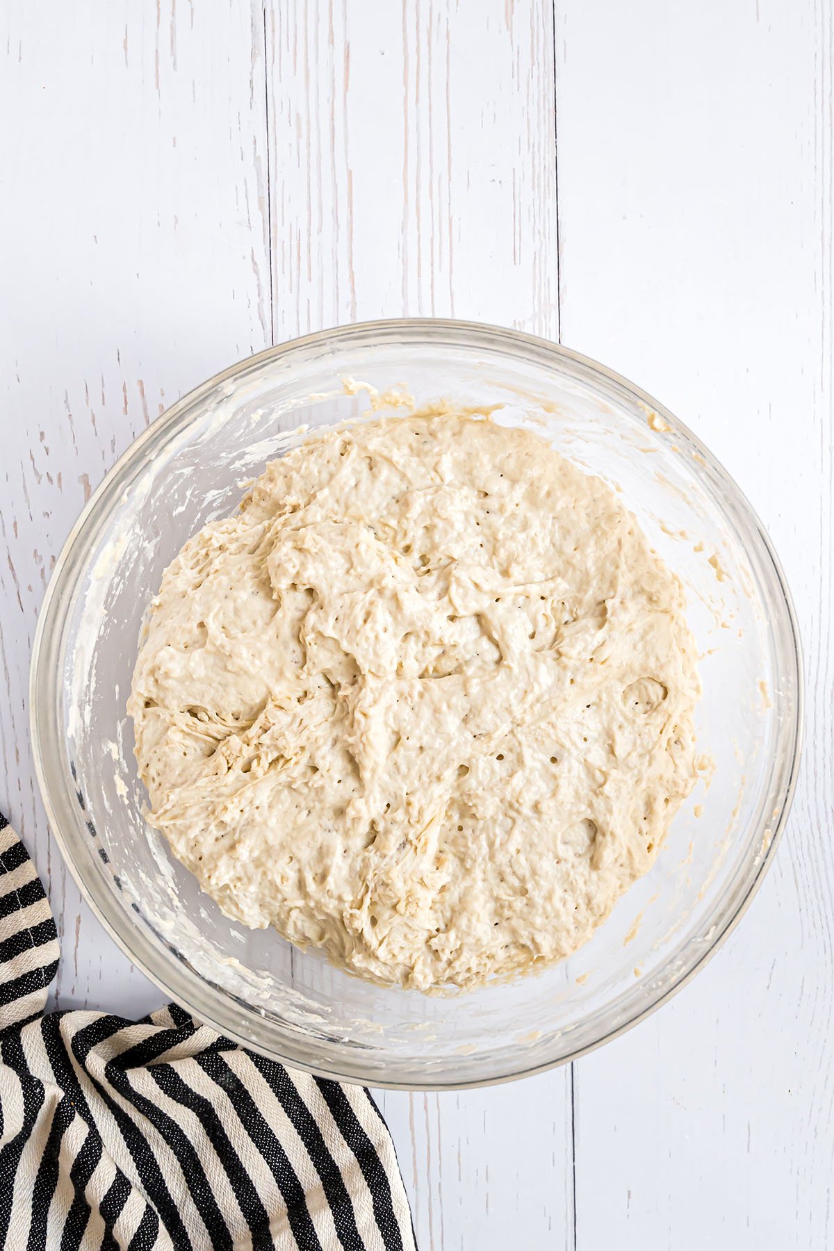 sourdough bread dough in a glass mixing bowl