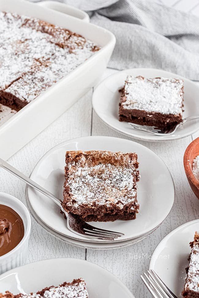 slices of Nutella cake on white plates on a counter
