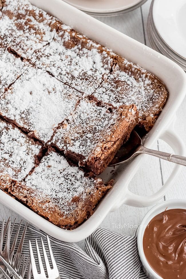 Sliced Nutella cake in a white pan