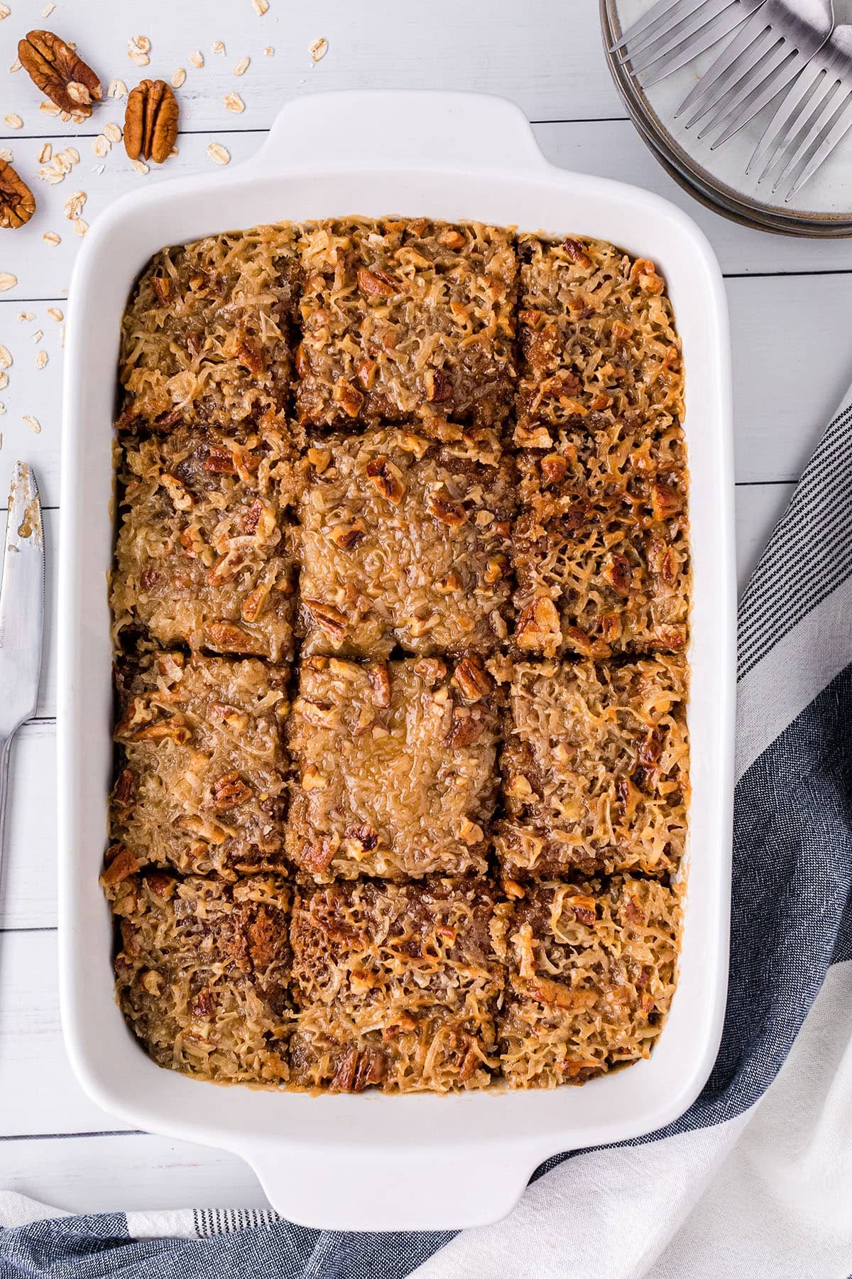 cut Oatmeal Cake in a white baking dish