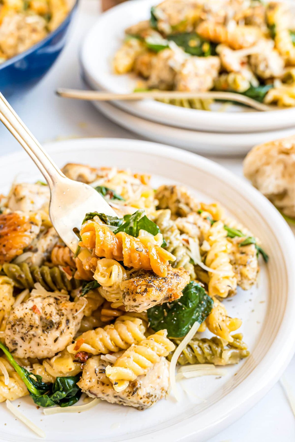 creamy garlic chicken pasta plated with a fork