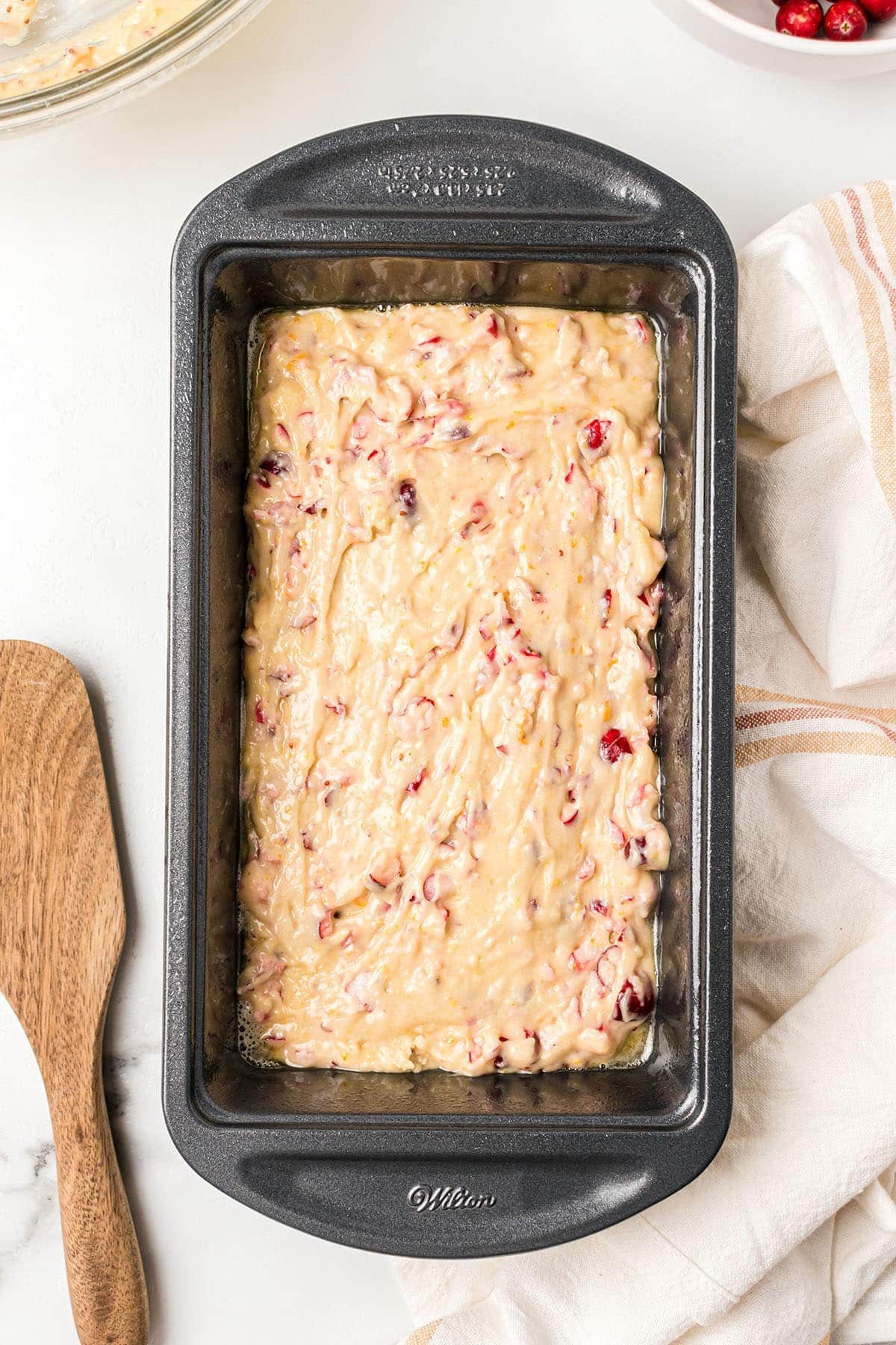 Orange Cranberry Bread batter in a loaf pan