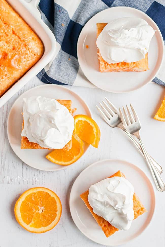 orange jello cake on white plates with orange slices