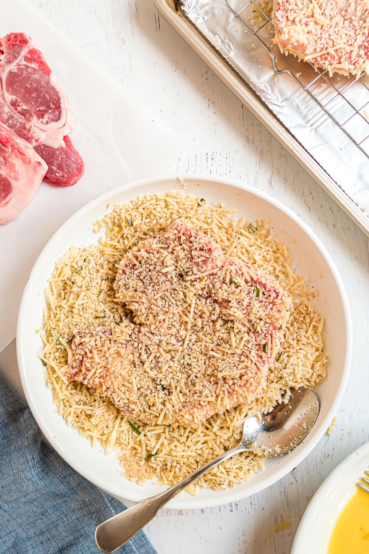 pork chop in a bowl of panko crumbs