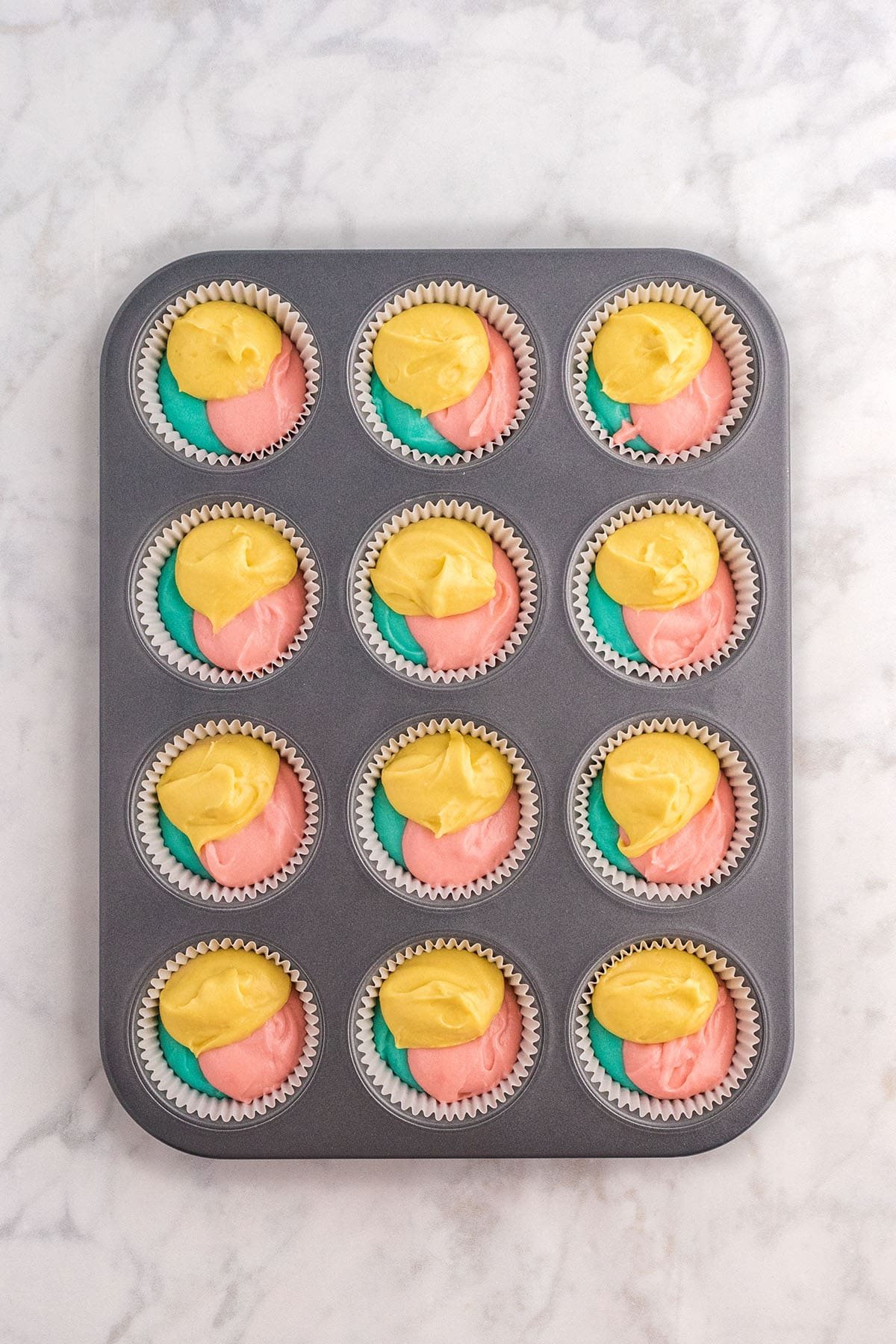 Spring color cake batter in cupcake pan