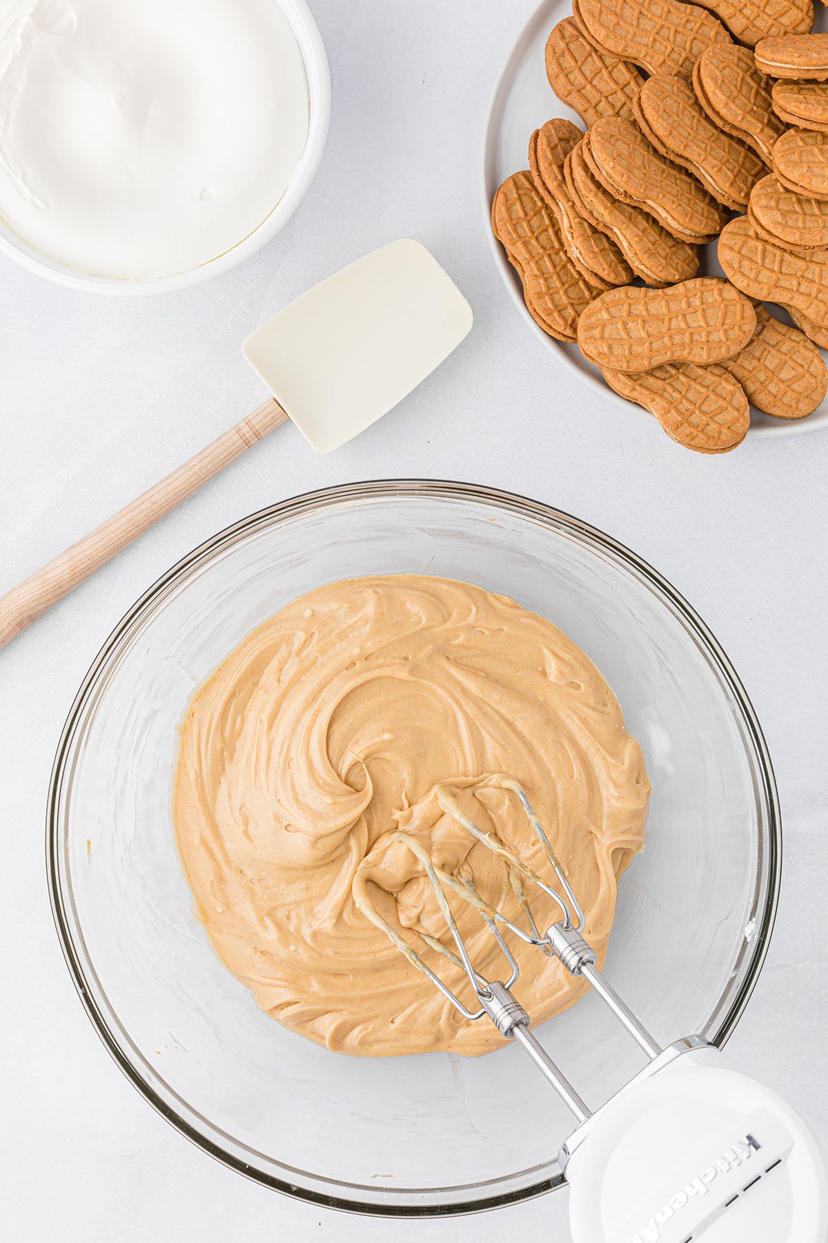 mixing peanut butter fluff layer for icebox cake in a glass bowl - step 2