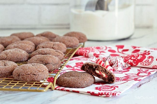 Super soft chocolate cookies hold a peppermint kiss in the center in these Peppermint Surprise Crinkle Cookies. So delicious
