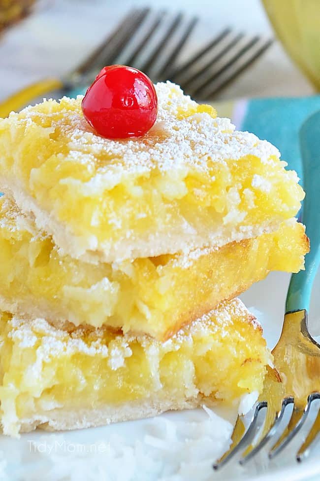 3 dessert bars stacked on a plate with forks