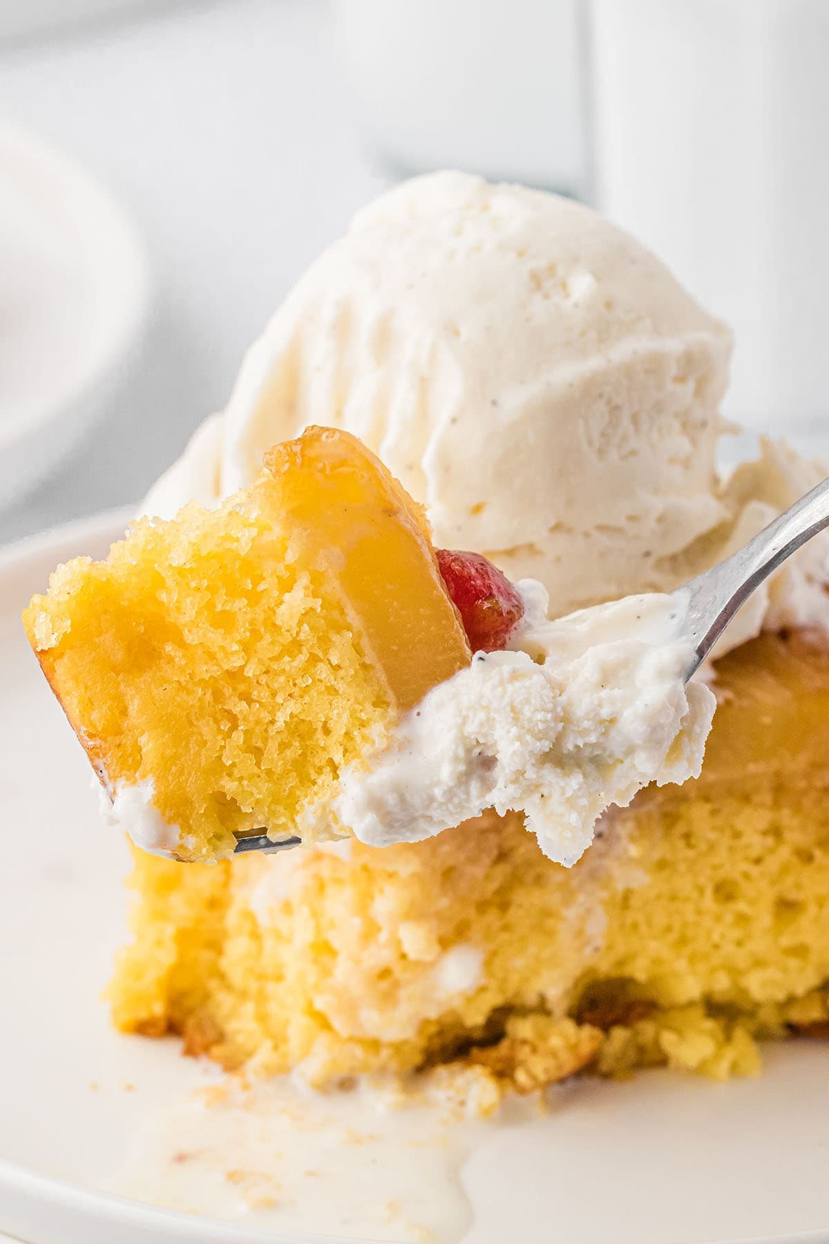 a bite of Pineapple Upside Down Cake on a fork