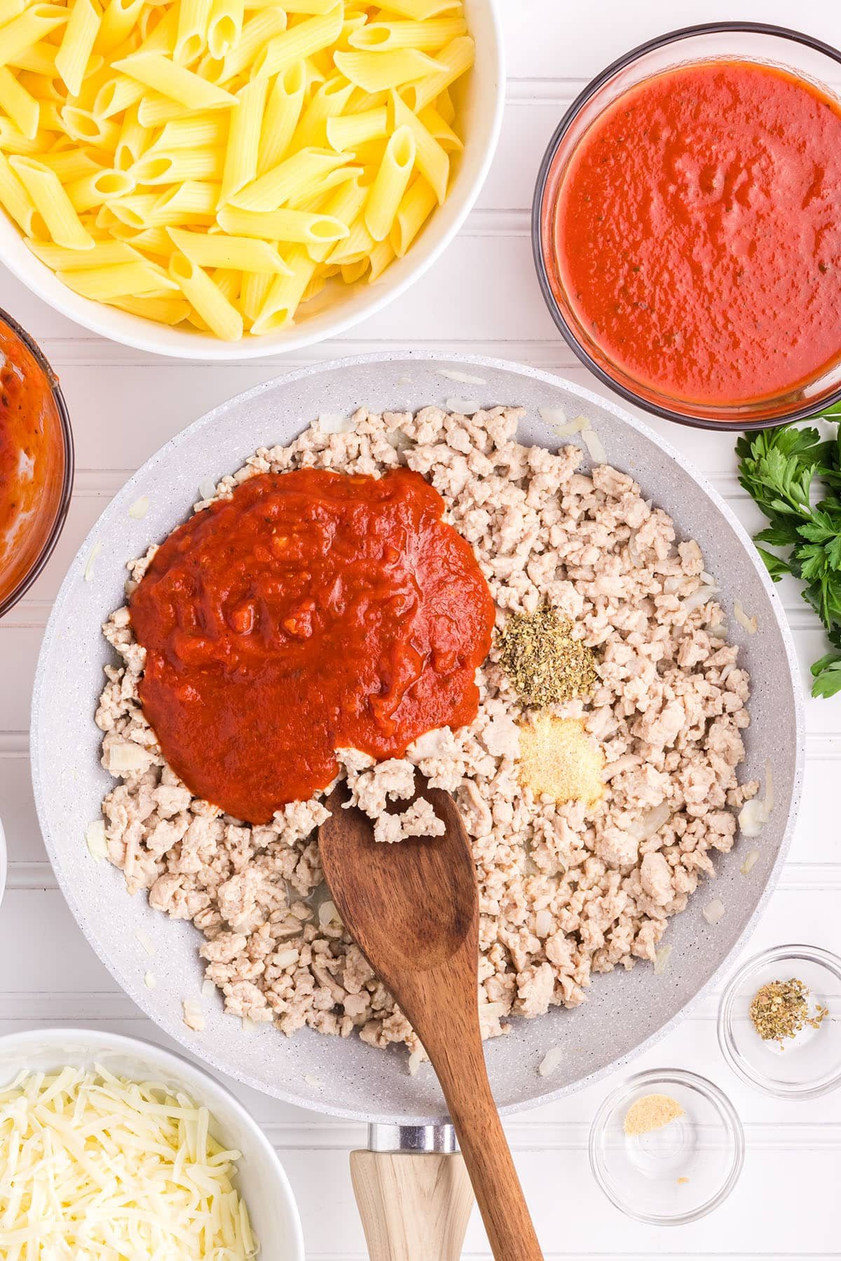 browning ground chicken with a sauce and seasonings in a skillet