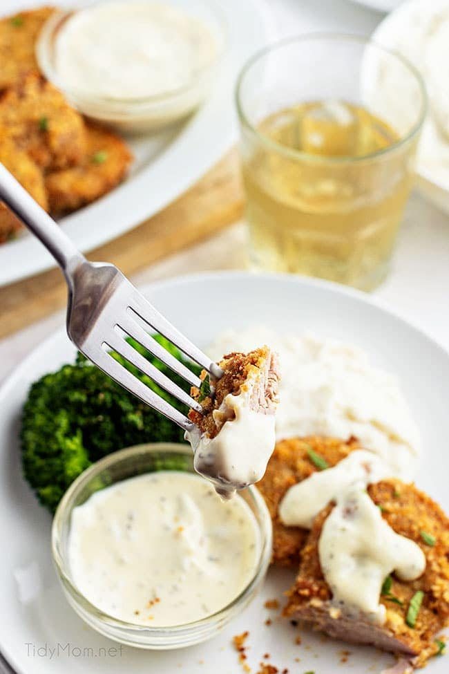 a bite of crispy pork medallions on a fork