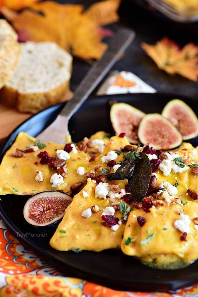 with butternut squash ravioli on black plate