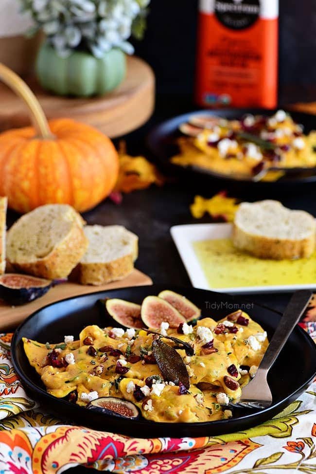 Pumpkin Alfredo ravioli on black plate