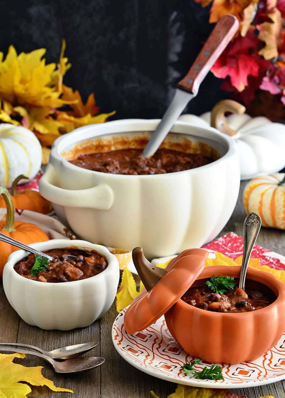 Fall table set with pumpkin bowls filled with chili