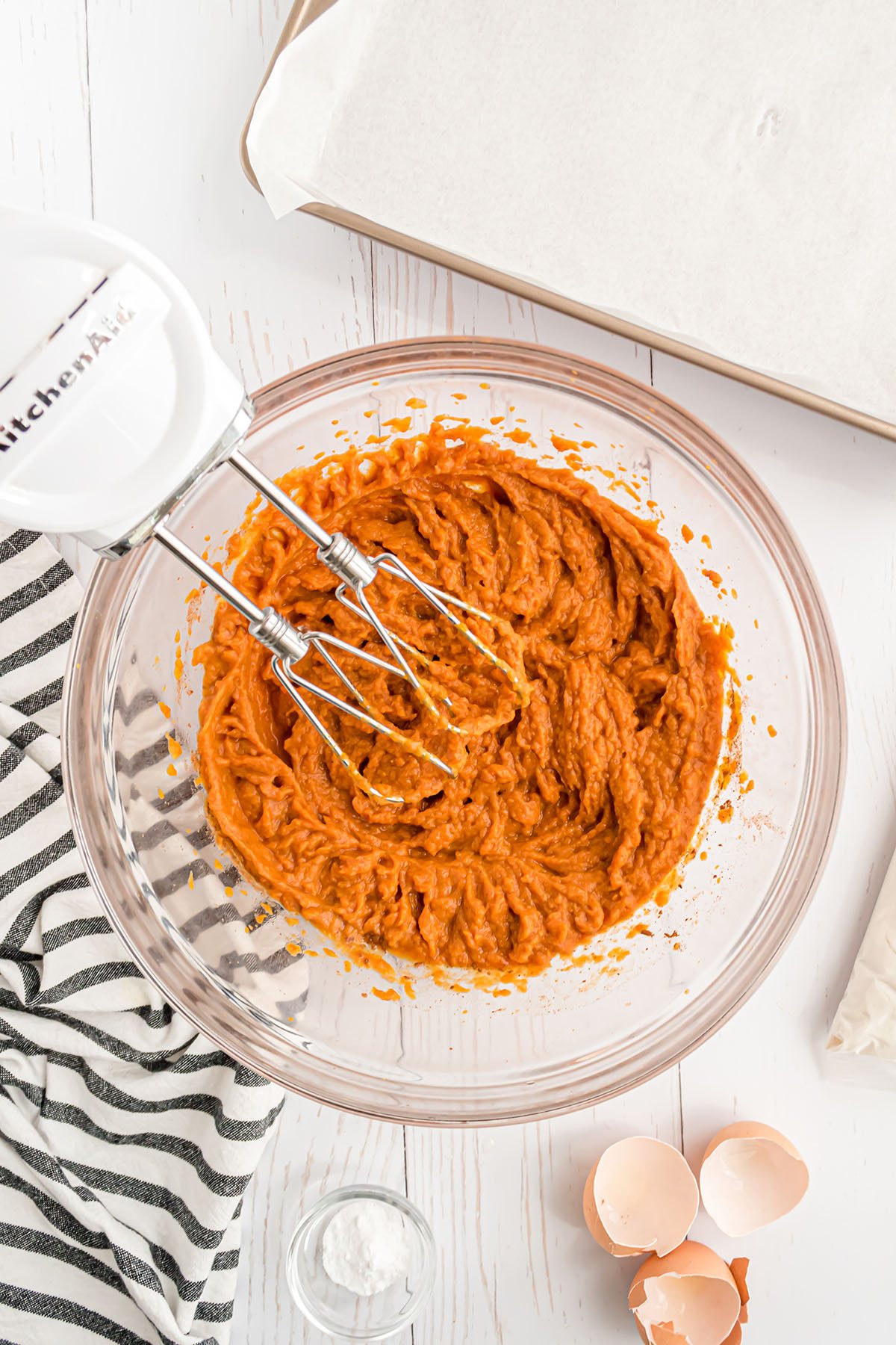 pumpkin coffee cake batter in a glass bowl with a hand mixer