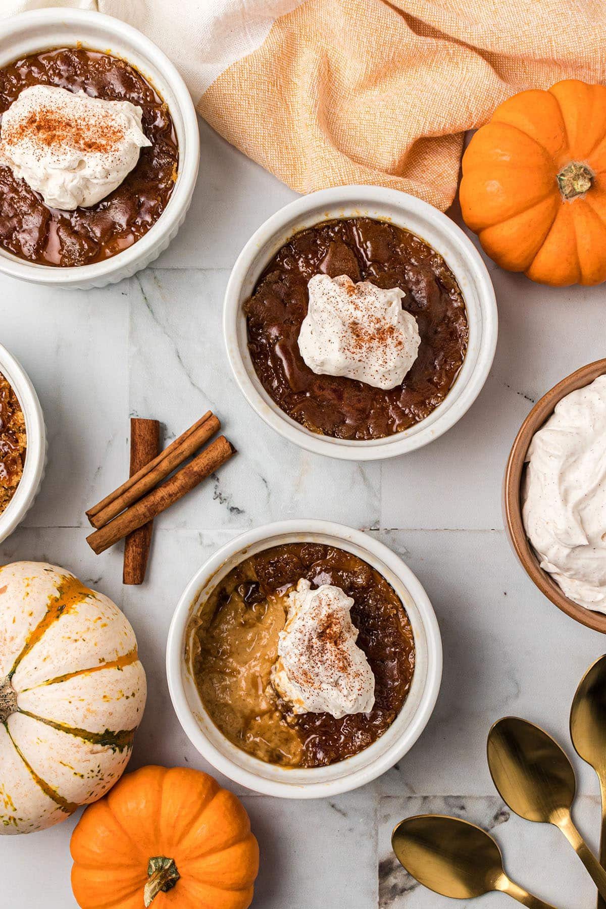 3 servings of Crème Brûlée with pumpkins around