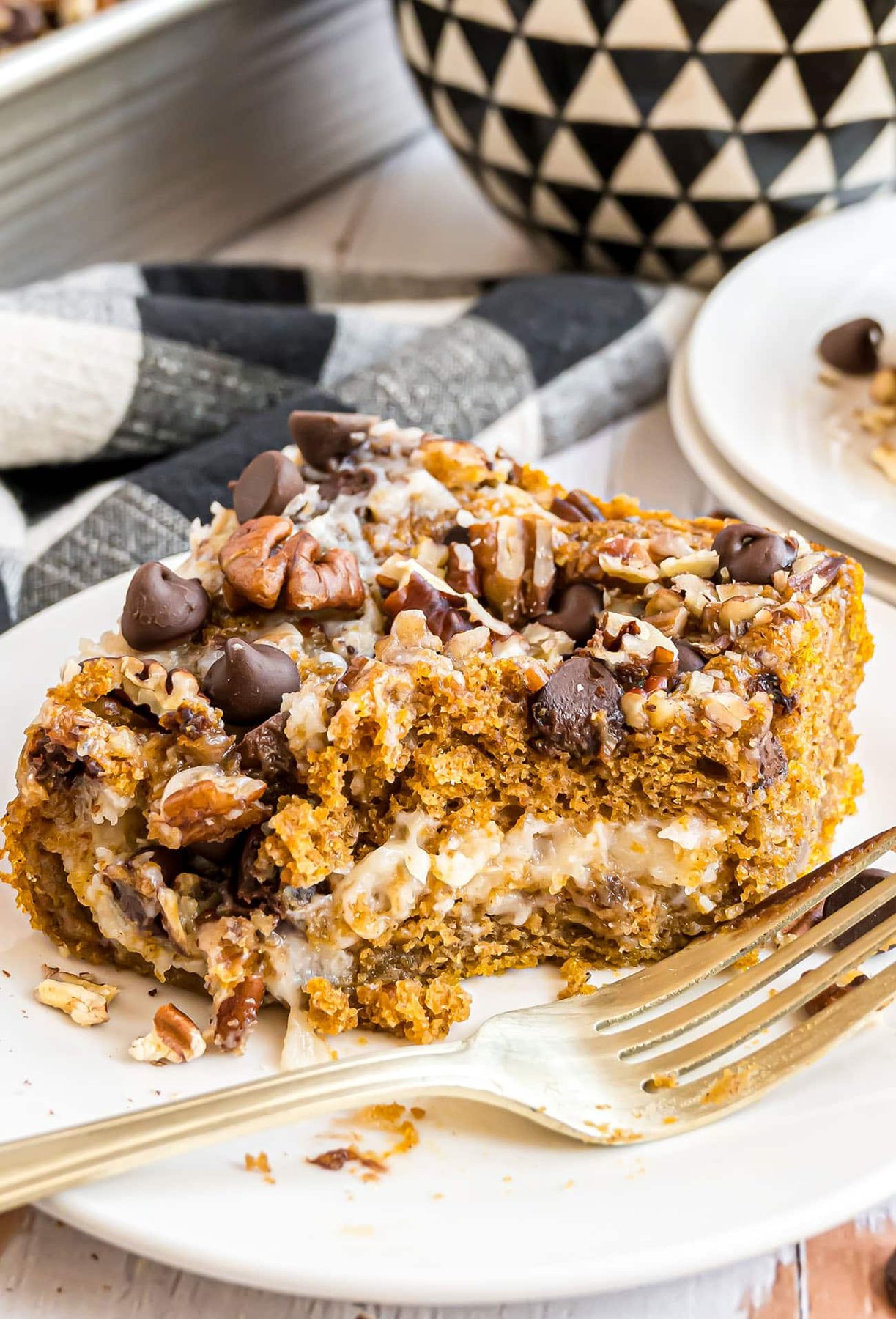 Earthquake Cake with pumpkin cut into a serving on a small plate with a fork