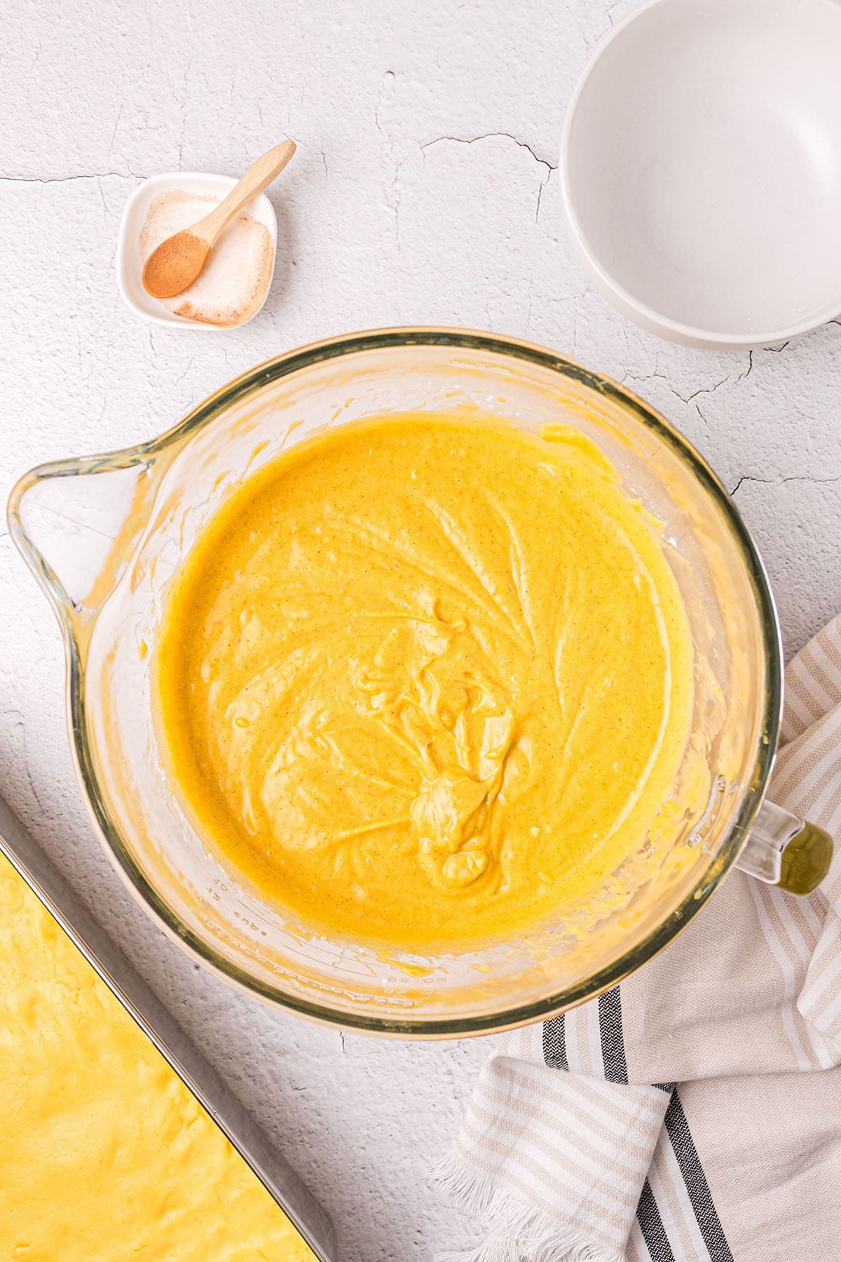 pumpkin gooey butter cake filling in a glass mixing bowl