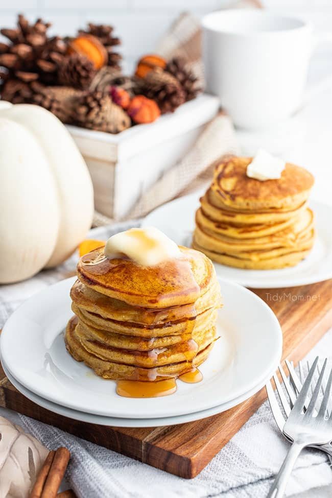 2 plates with a stack of pancakes on white plates